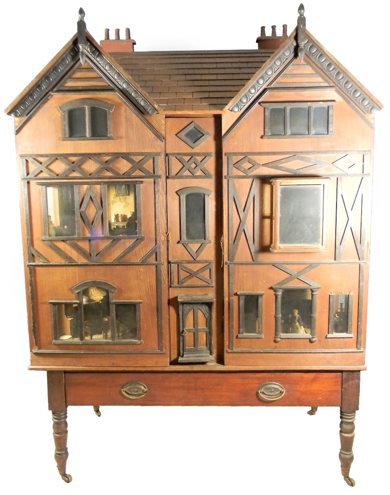 A large and impressive wooden dolls house and contents on stand, probably German circa 1880,
