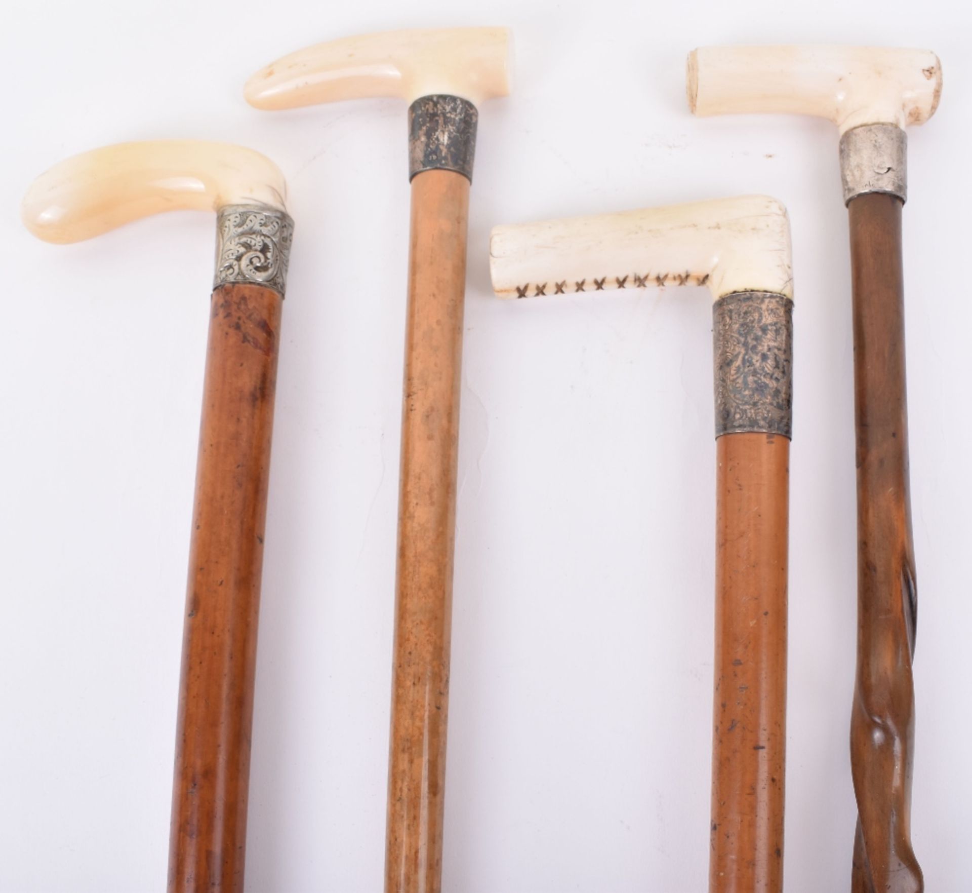 ^Four late 19th century ivory walking sticks