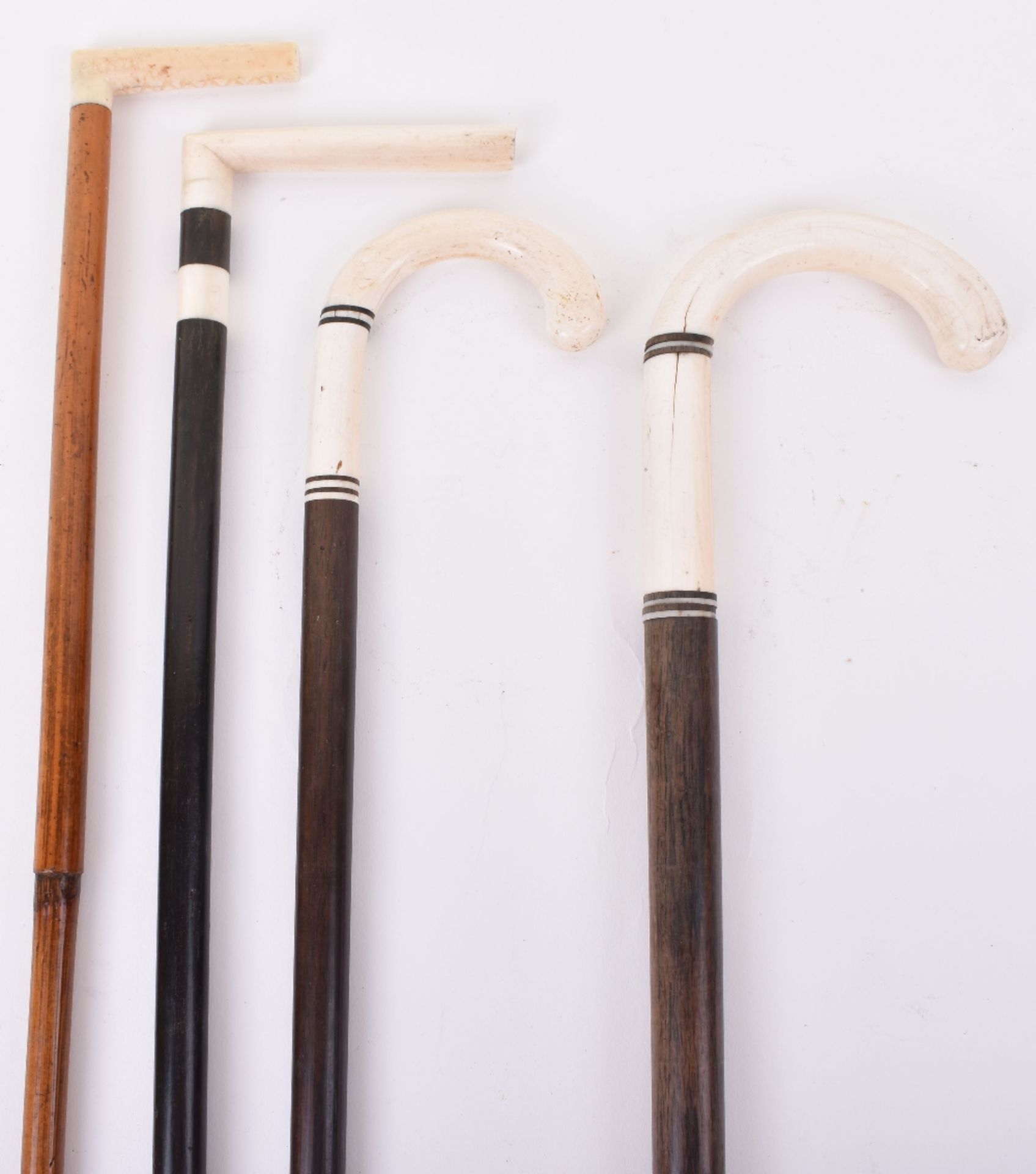 ^Four early 20th century ivory and bone handle walking sticks