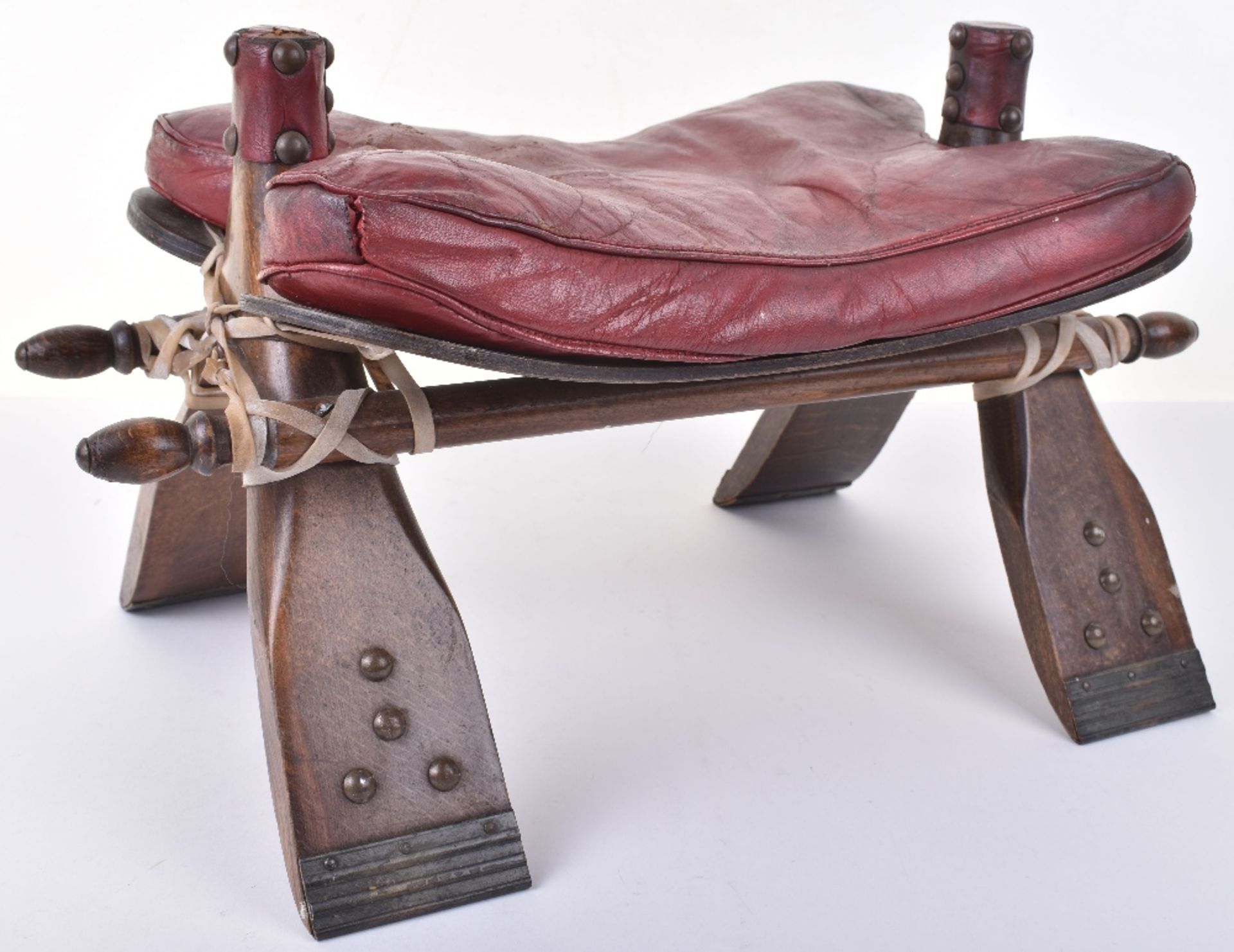 An early 20th century camel seat, leather seat and stud work