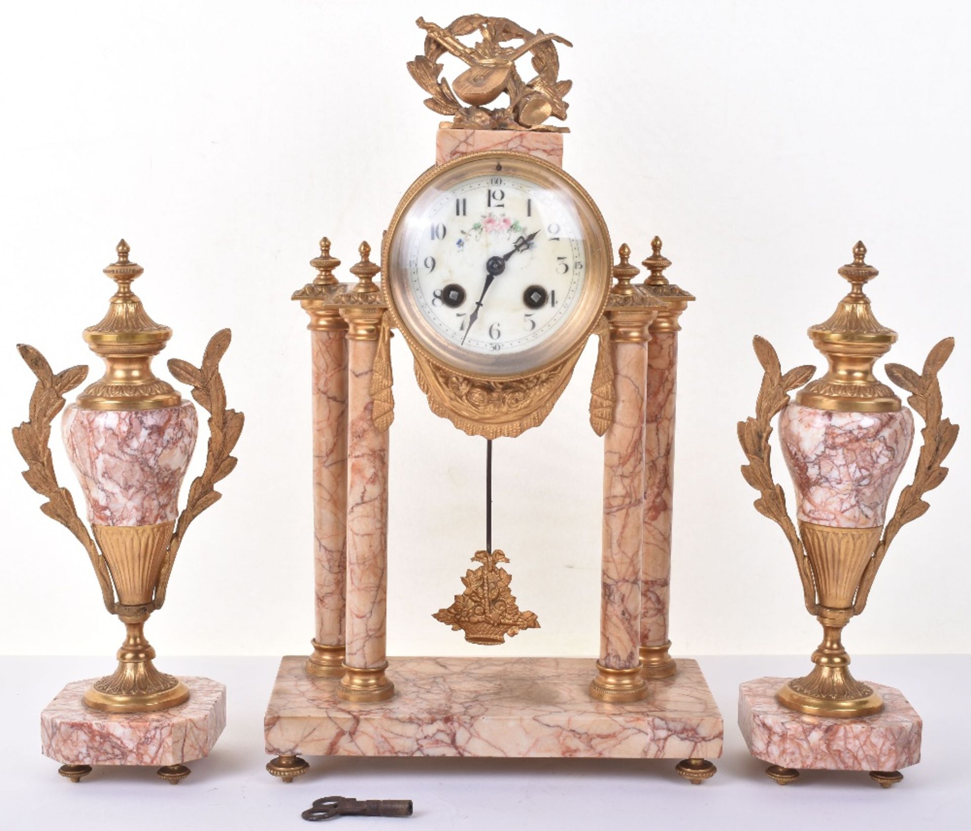 A late 19th century French rose marble clock garniture