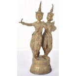 An early 20th century brass figure group of two Thai dancers in traditional dress