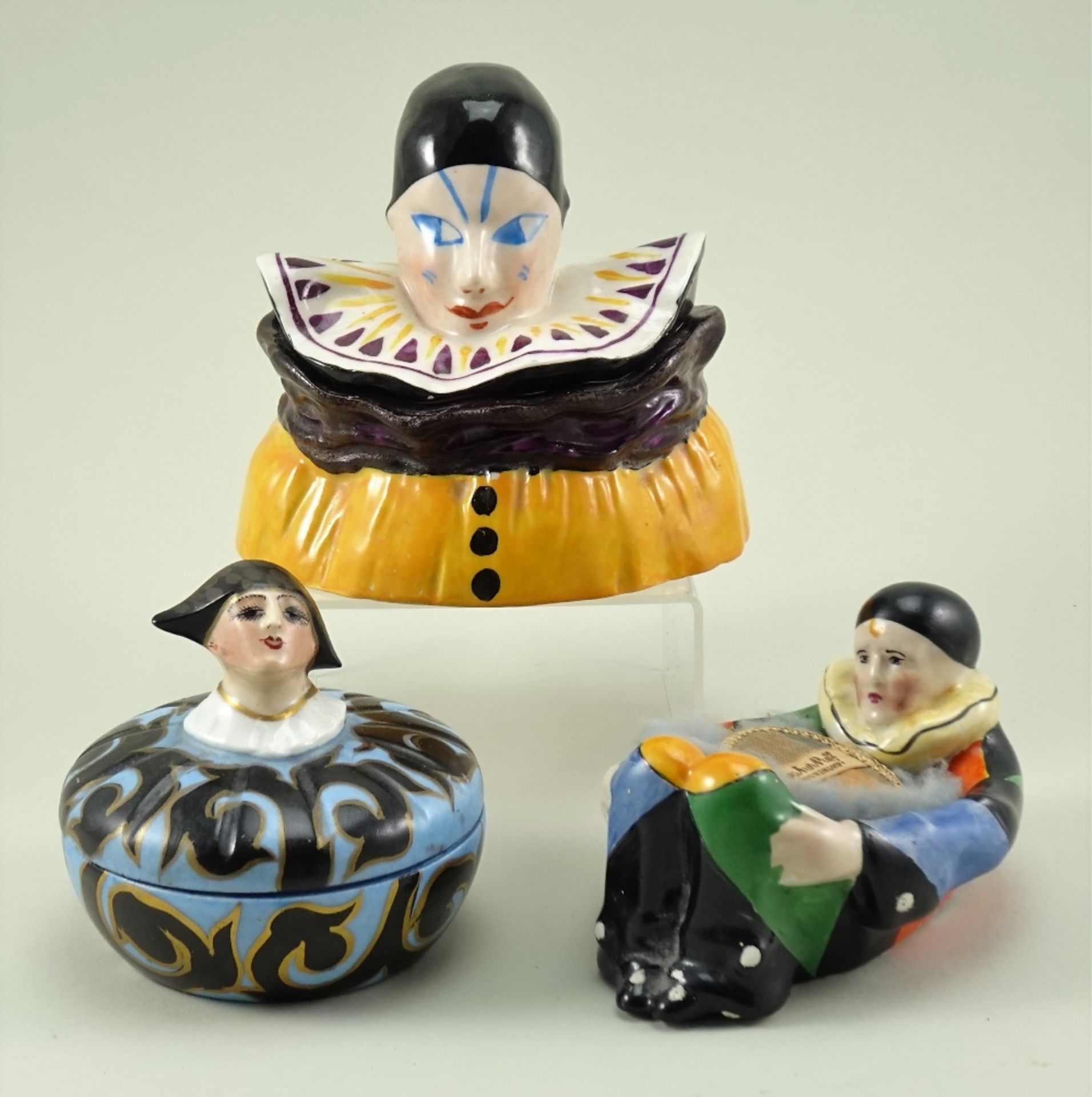 Two glazed china dressing table boxes and a powder puff dish, 1920s,