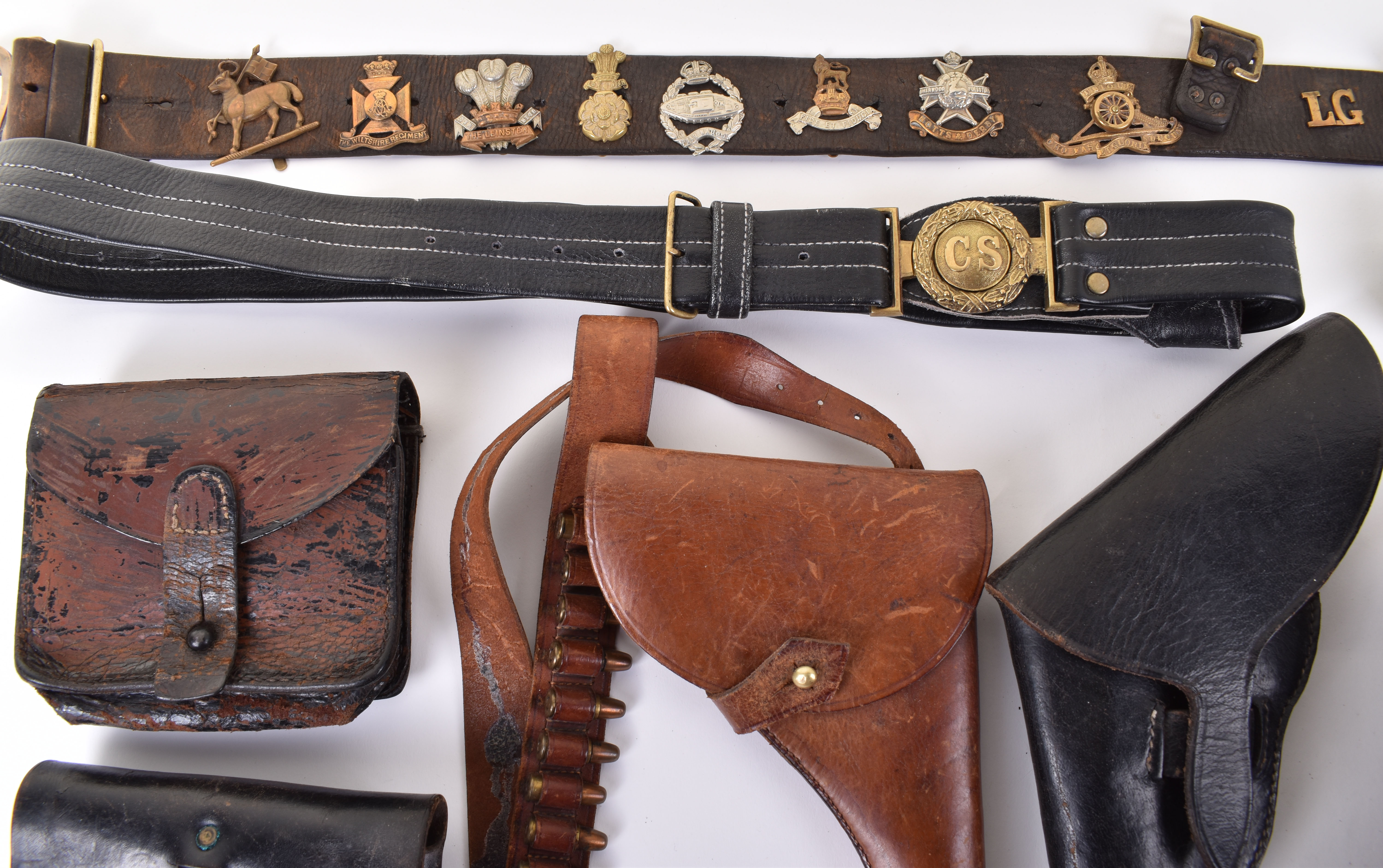 A selection of leather gun holsters and belts, including a selection of ...