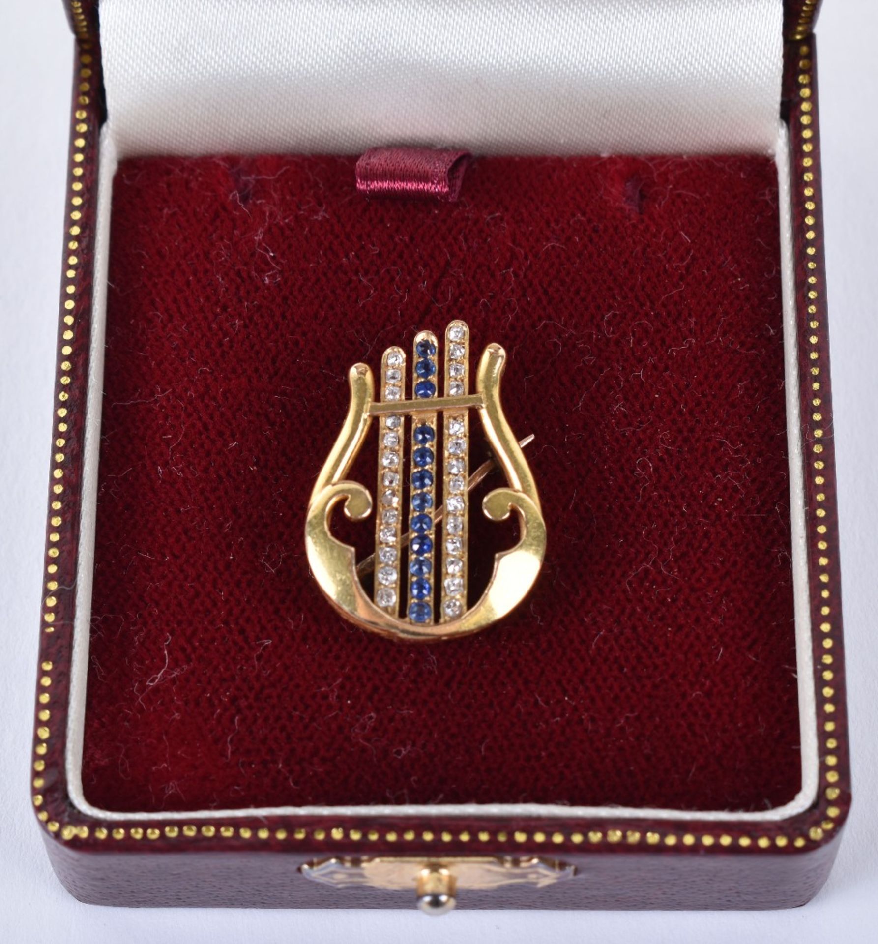 An unmarked gold, diamond and sapphire brooch