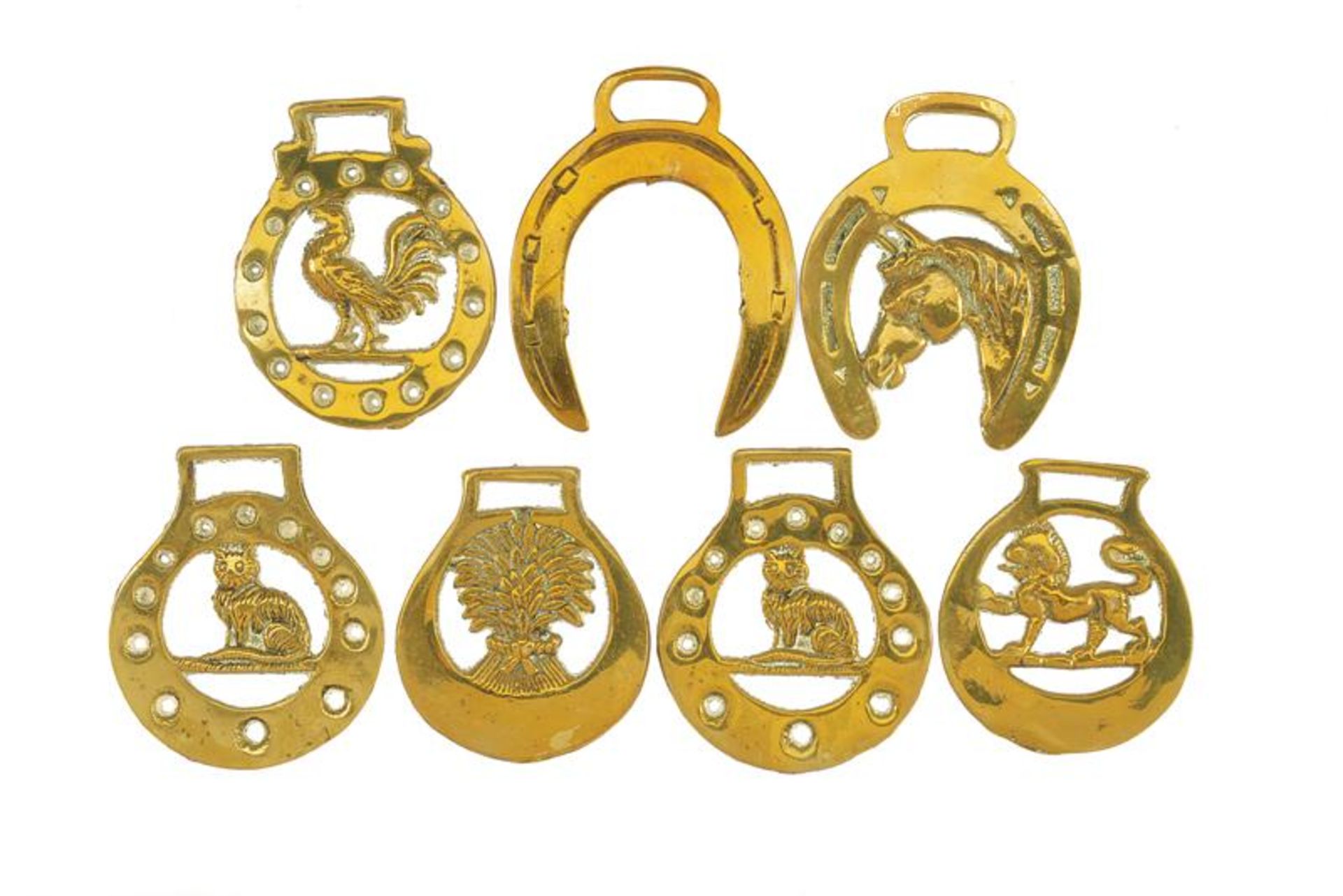 A lot of seven pendants for horses