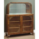 Early 20th century walnut display cabinet, two glass sliding doors enclosing mirrored interior,