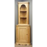 20th century waxed pine corner cabinet, two shaped shelves above single panelled door, W68cm,