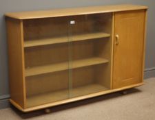 Ercol style sideboard with sliding glass doors enclosing two shelves,