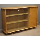 Ercol style sideboard with sliding glass doors enclosing two shelves,