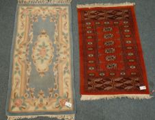 Bokhara red ground rug, geometric medallions (78cm x 120cm),