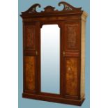 Large Edwardian walnut wardrobe, swan neck pediment with carvings, projecting cornice,