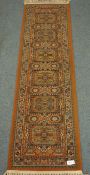 Persian red ground runner rug, six repeating medallions,