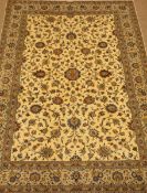 Large Persian Kashan ivory ground carpet, blue trailing foliage pattern, repeating border,