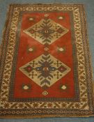 Turkish red ground rug, two equal set medallions with repeating star border,