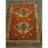 Turkish red ground rug, two equal set medallions with repeating star border,