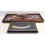 Eight Franklin Mint knives, short 'Samurai Sword' with dragon decoration, in display case,