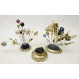Two silver-plated hat pin stands, one centred with thistle finial,