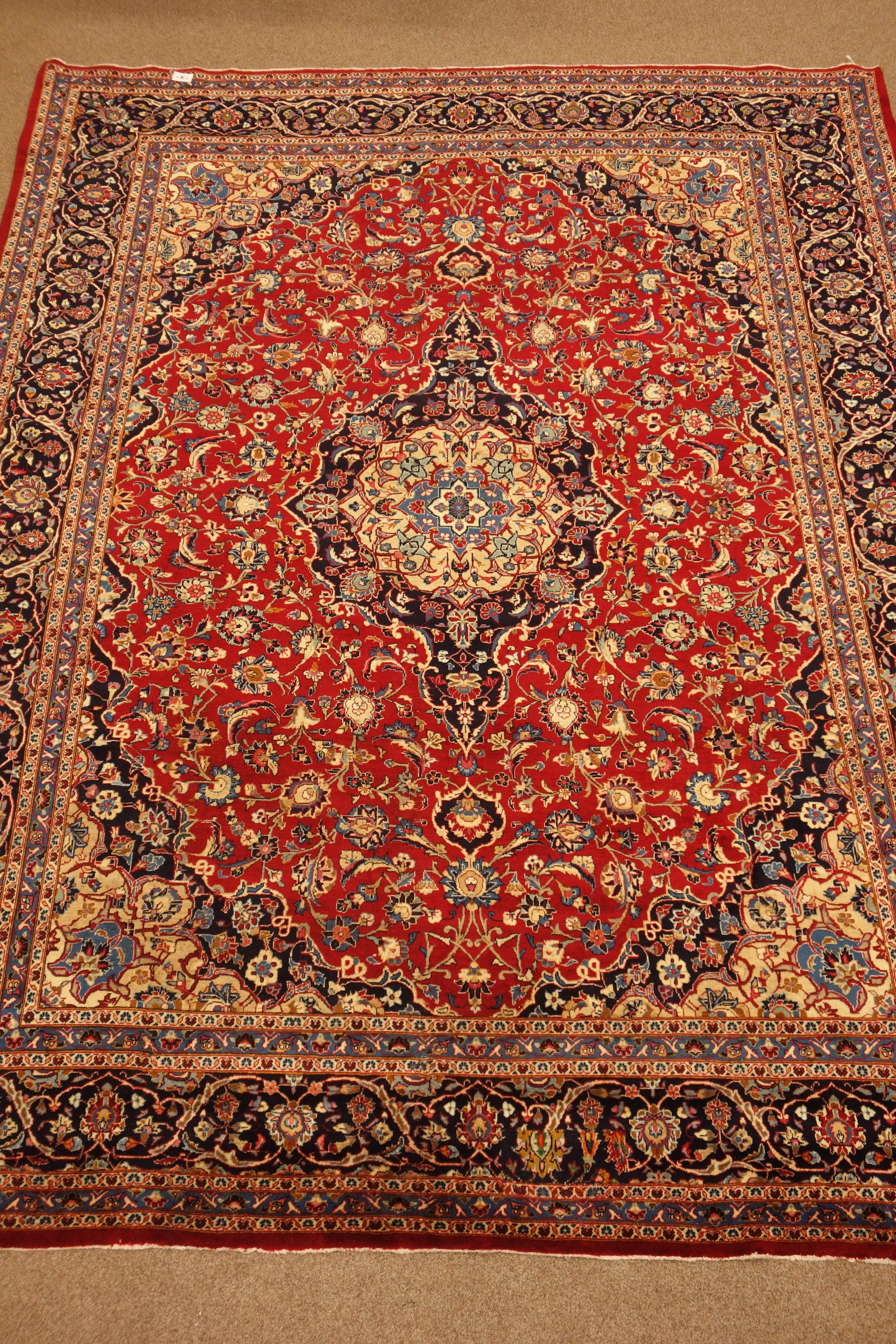 Persian Meshed red ground rug carpet, pointed medallion with rosette,