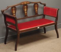 Edwardian inlaid mahogany two seat salon settee, upholstered in red fabric, shaped supports, W111cm,