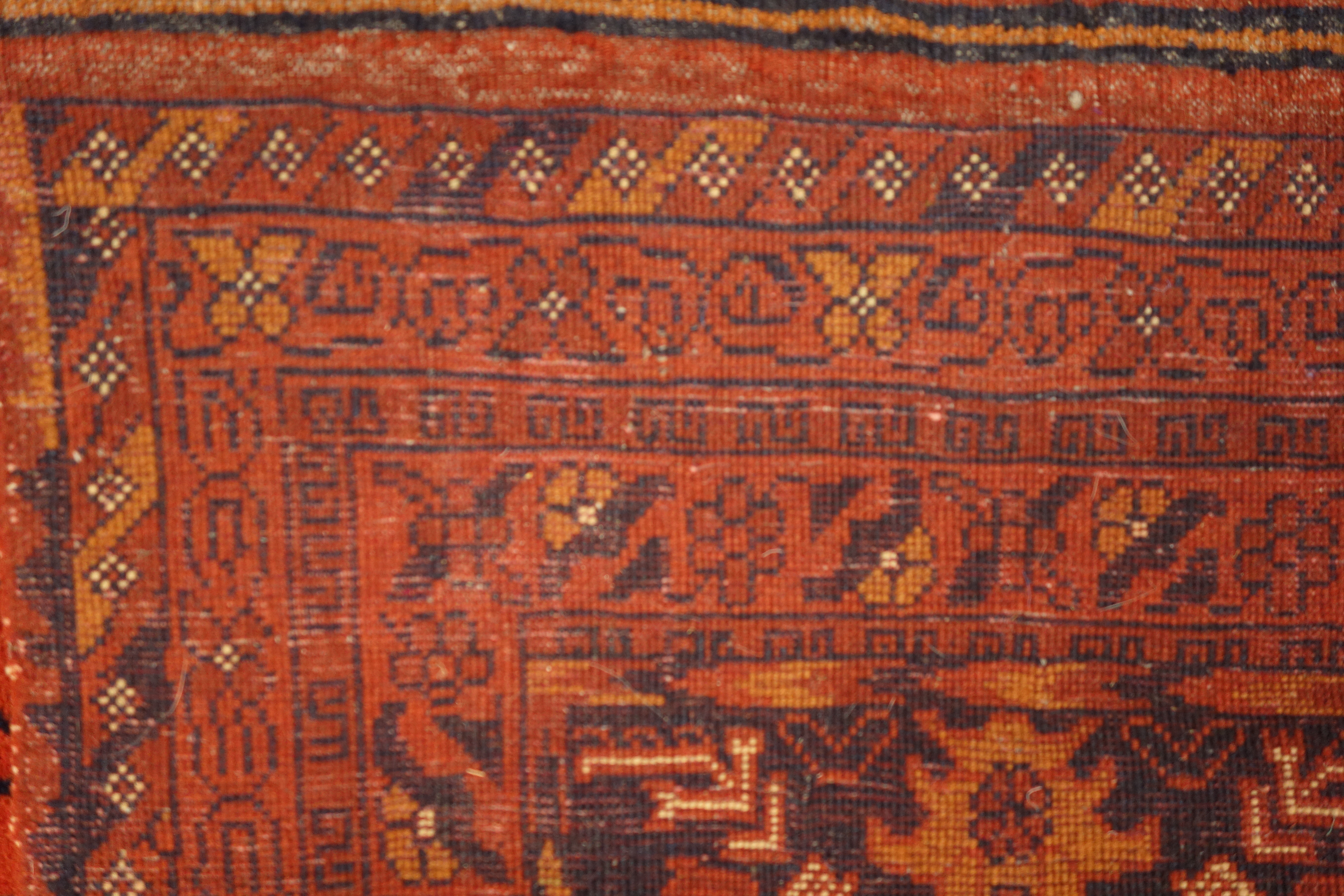 Persian Bokhara red ground rug, repeating floral border, - Image 3 of 3