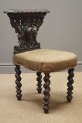 Late 19th century oak reading chair, carved with hound mask and foliage, barley twist supports,