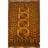Bokhara orange ground rug, four central medallions, mirrored lozenge, repeating border,