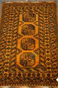 Bokhara orange ground rug, four central medallions, mirrored lozenge, repeating border,
