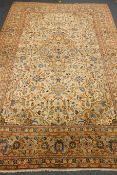 Persian Kashan pale yellow ground rug, central geometric medallion,