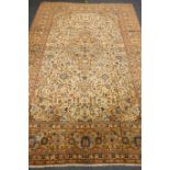 Persian Kashan pale yellow ground rug, central geometric medallion,