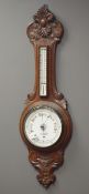 Early 20th century carved oak cased aneroid barometer with thermometer,