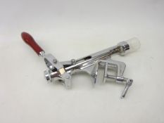 Counter top wine bottle cork remover with screw fitting, chromed metal body with red handle,