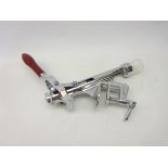 Counter top wine bottle cork remover with screw fitting, chromed metal body with red handle,