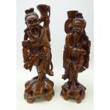 Large matched pair of Chinese hardwood figures each carved from the solid as a fisherman with inset