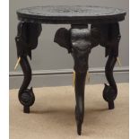 Anglo-Indian hardwood occasional table, black finish, heavily carved top and elephant supports,