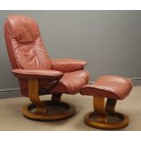 Stressless reclining armchair and stool, upholstered in maroon leather,