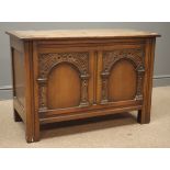 Early 20th century oak chest, hinged lid, double arched front carved with foliage, stile supports,