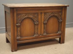 Early 20th century oak chest, hinged lid, double arched front carved with foliage, stile supports,