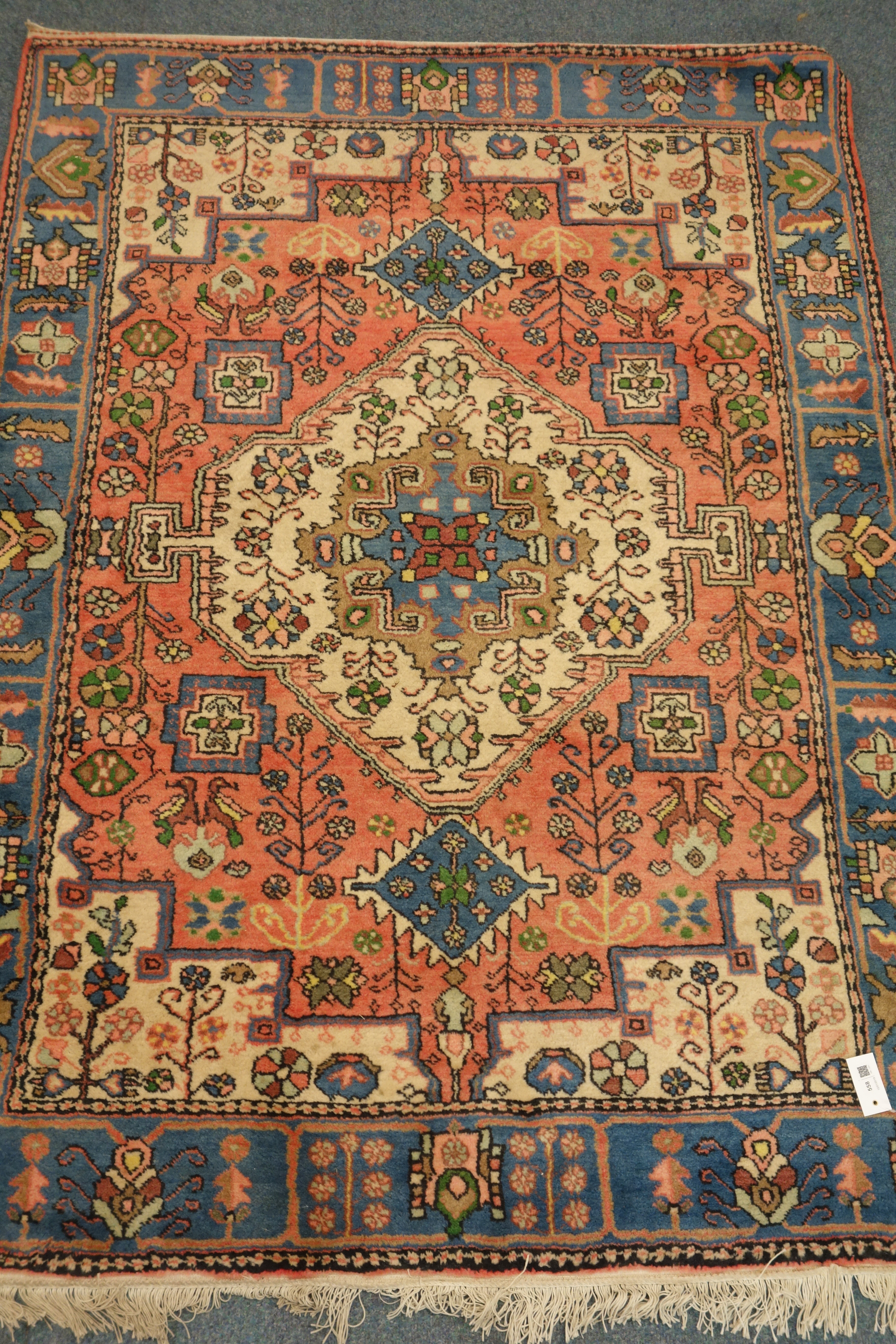 Persian red ground rug, blue border,