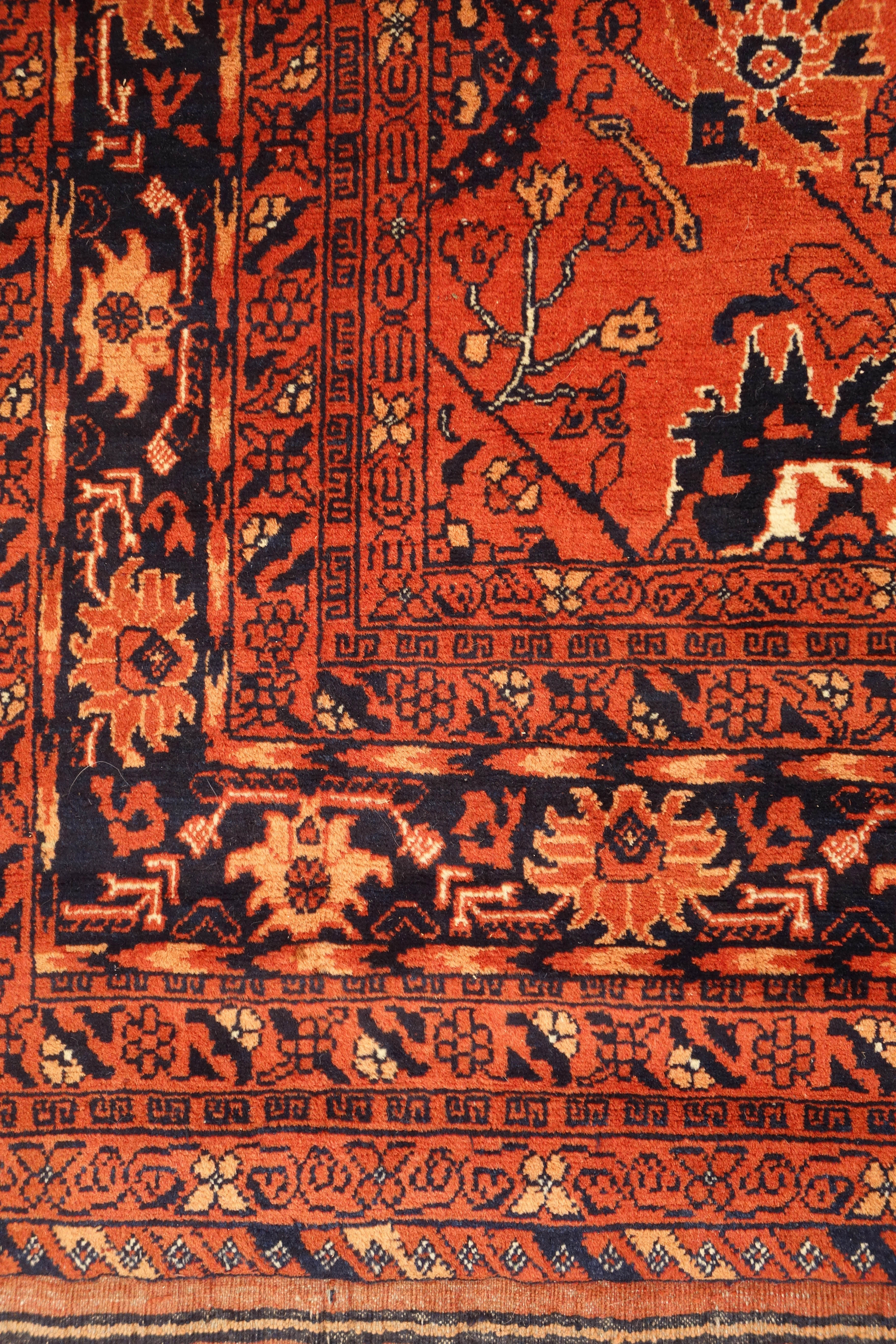 Persian Bokhara red ground rug, repeating floral border, - Image 2 of 3