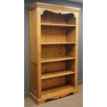 Pine open book case, projecting cornice, dentil and shaped frieze, four shelves, shaped plinth base,