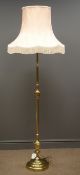 Brass standard lamp with pink lamp shade,