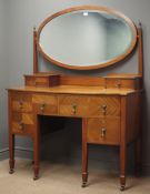 Edwardian mahogany serpentine dressing table, raised oval bevel edged mirror,