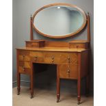 Edwardian mahogany serpentine dressing table, raised oval bevel edged mirror,