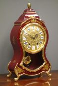 'Eluxa' French style mantel clock, cartouche shaped red lacquered and gilt decorated case,