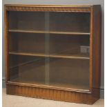 Mid 20th century oak bookcase with sliding glass doors, enclosing two adjustable shelves,