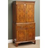 Quality reproduction figured mahogany serpentine cocktail cabinet, double cupboard above slide,