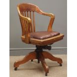 Early 20th century oak swivel office armchair, leather upholstered seat, splayed supports,