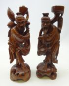 Pair of Chinese hardwood figures carved from the solid with inset facial features,