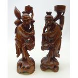 Pair of Chinese hardwood figures carved from the solid with inset facial features,